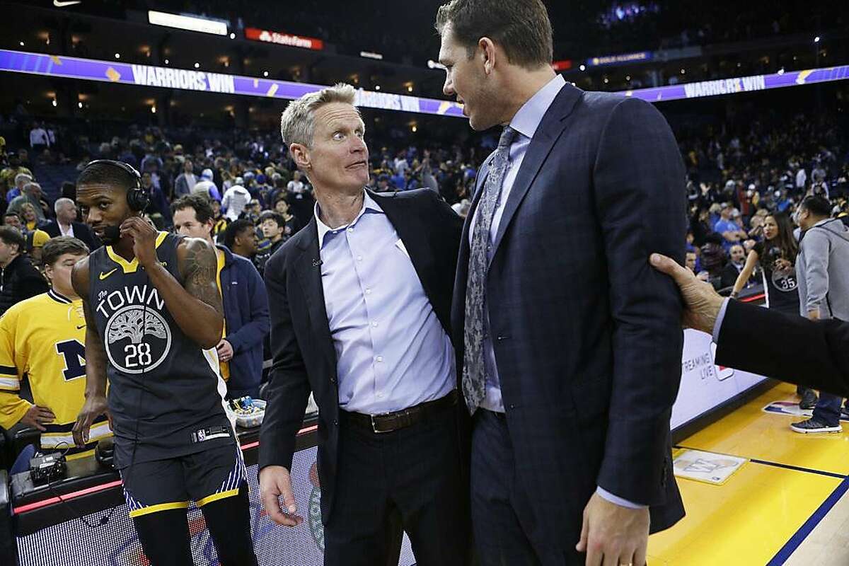 FILE – Golden State Warriors head coach Steve Kerr with Los Angeles Lakers head coach Luke Walton following the end of the NBA game at Oracle Arena in Oakland in this file photo from Feb. 2, 2019 taken in Oakland. The Warriors won 115-101. Walton, who was fired from the Los Angeles Lakers after coaching them for three seasons, served as an assistant coach to Warriors head coach Kerr before coaching the Lakers. Kerr spoke on his firing after the Warriors' practice, saying that Walton is "one of the best humans in the NBA."