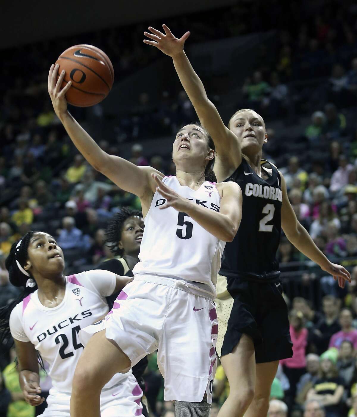 Oregon's Ruthy Hebard, left, sets a screen on Colorado's Mya Hollingshed, second from left, as Oregon's Maite Cazorla (5) goes up to shoot ahead of Colorado's Alexis Robinson (2) during the second quarter of an NCAA college basketball game Sunday, Feb. 3, 2019, in Eugene, Ore. (AP Photo/Chris Pietsch)