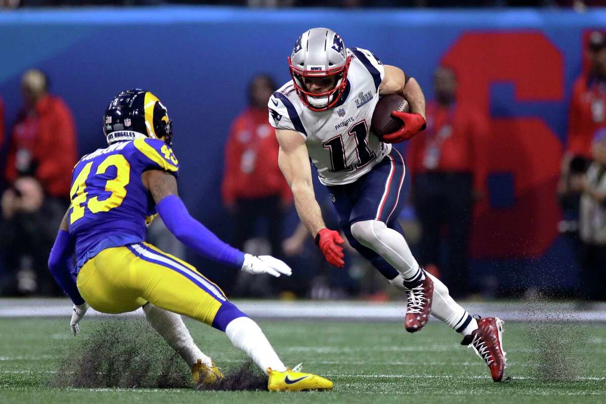 New England Patriots' Julian Edelman, right, tries to elude Los Angeles Rams' John Johnson III (43) after catching a pass during the second half of the NFL Super Bowl 53 football game Sunday, Feb. 3, 2019, in Atlanta.