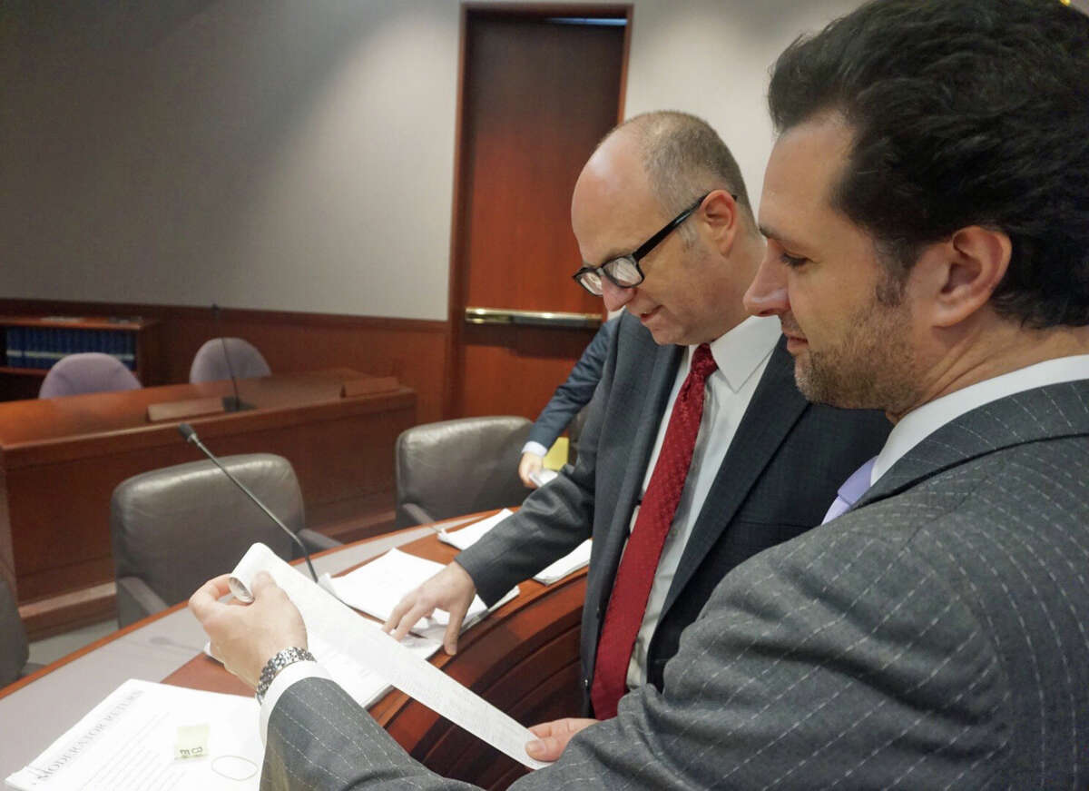 State Reps. Gregory Haddad (left), D-Storrs, and Michael D'Agostino, D-Hamden, examined election evidence together at a meeting of the Committee on Contested Elections at the Legislative Office Building in Hartford, Conn. on Friday February 1, 2019.