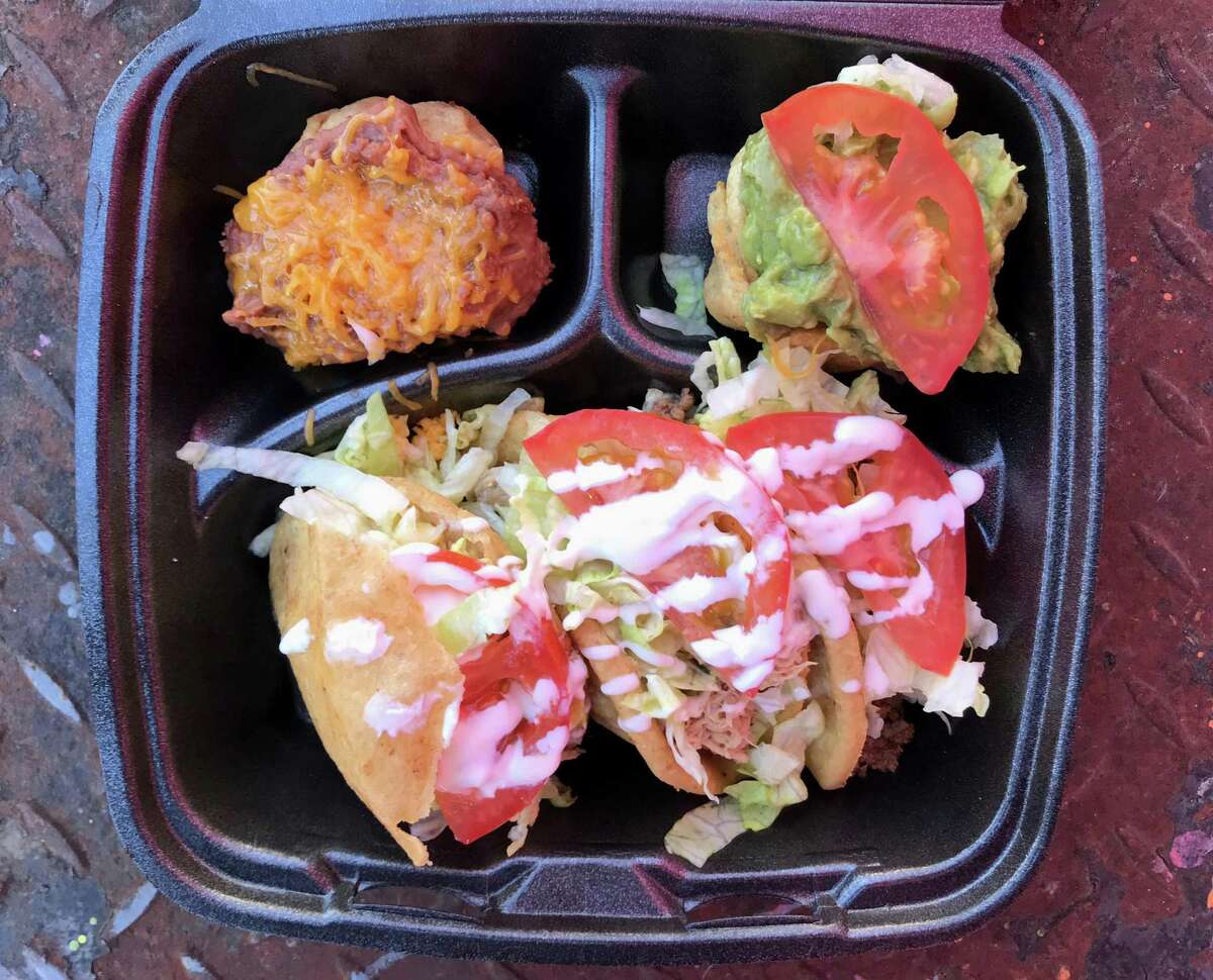 A bean cup, a guacamole cup, two puffy tacos and a chicken gordita from Lala's Gorditas