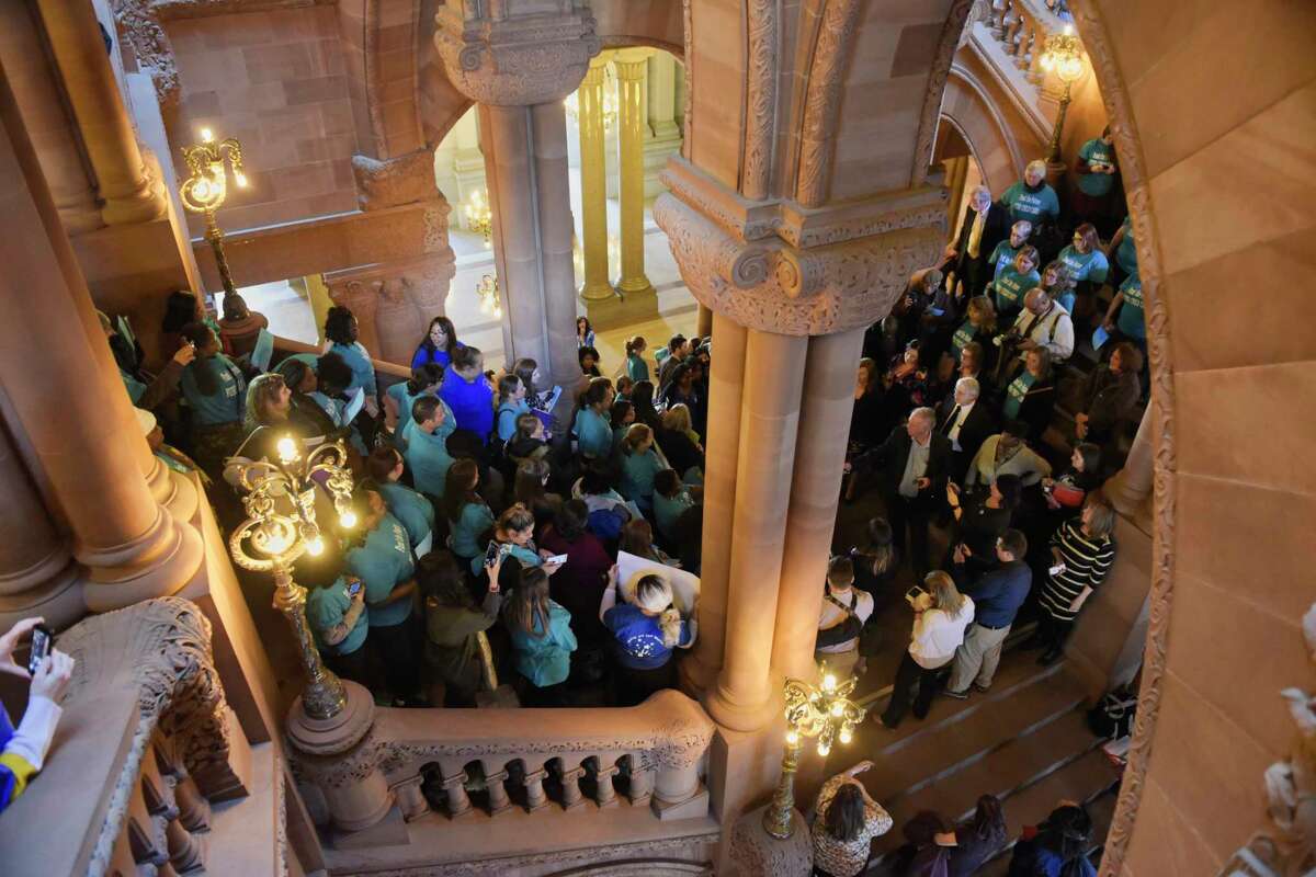 People gather on the Million Dollar Staircase at the Capitol to call for more funding for New York?•s child care system on Monday, Feb. 4, 2019, in Albany, N.Y. (Paul Buckowski/Times Union)