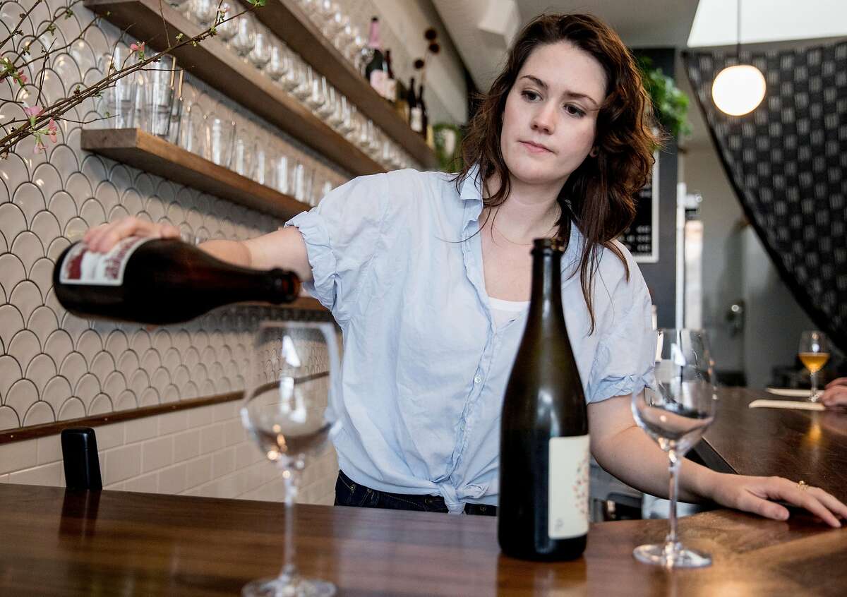 Owner Olivia Maki pours a glass of Eve's Cidery's Darling Creek dry cider behind the bar of Redfield Cider Bar in Oakland, Calif. Saturday, Feb. 2, 2019.