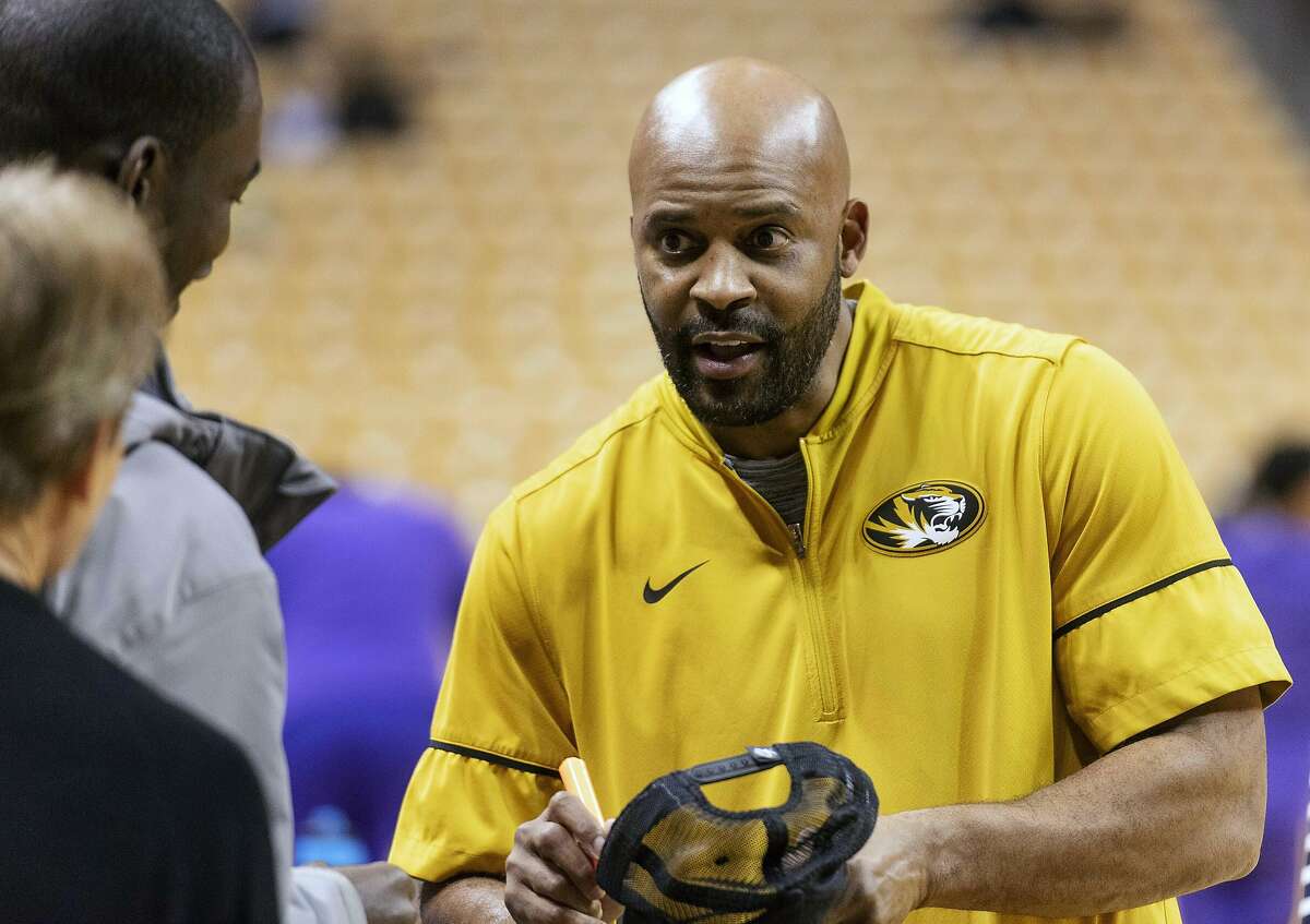 FILE - In this Jan. 26, 2019 file photo Missouri head coach Cuonzo Martin signs autographs for fans before an NCAA college basketball game against LSU in Columbia, Mo. Martin returns to Thompson-Boling Arena as a visiting coach for the first time Tuesday, Feb. 5, 2019 when his Missouri team faces the top-ranked Volunteers. Martin, who coached Tennessee from 2011-14 but never won over the fan base, now must try to snap the Vols’ school-record 16-game winning streak. (AP Photo/L.G. Patterson, file)