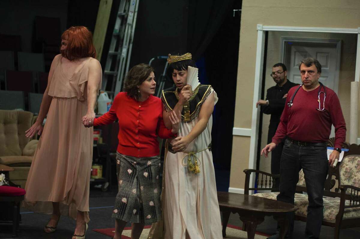 A pair of down-on-their-luck Shakespearean actors (Jared Stephens, left and Andrew Olmos, in the crown, shown in rehearsal) present themselves as women in hopes of scoring a fortune in the farce “Leading Ladies.” Maggie Tonra (center) and Scott Leibowitz are among the folks who buy into the charade.