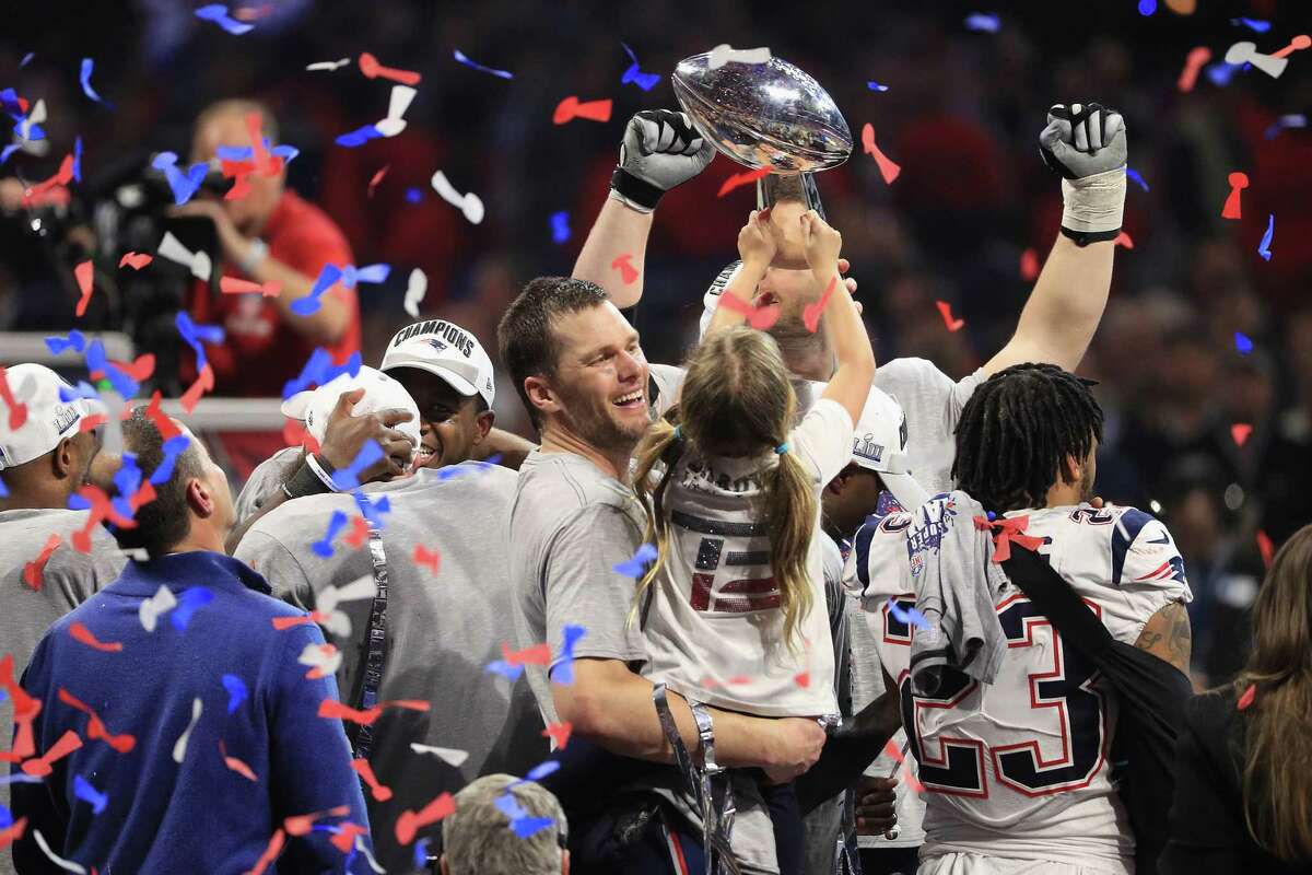 Tom Brady, No. 12, of the New England Patriots celebrates with daughter Vivian who raises the Vince Lombardi Trophy after Super Bowl LIII at Mercedes-Benz Stadium on February 3, 2019 in Atlanta, Georgia. The New England Patriots defeat the Los Angeles Rams 13-3. (