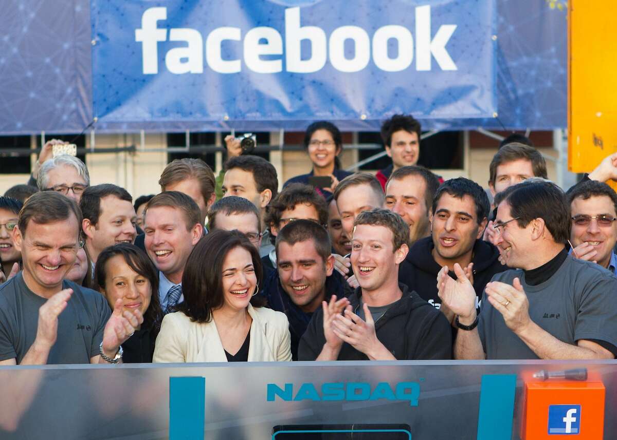In this image provided by Facebook, Facebook founder, Chairman and CEO Mark Zuckerberg, center, applauds at the opening bell of the Nasdaq stock market, Friday, May 18, 2012, from Facebook headquarters in Menlo Park, Calif. The social media company priced its IPO on Thursday at $38 per share, and beginning Friday regular investors will have a chance to buy shares. (AP Photo/Nasdaq via Facebook, Zef Nikolla)