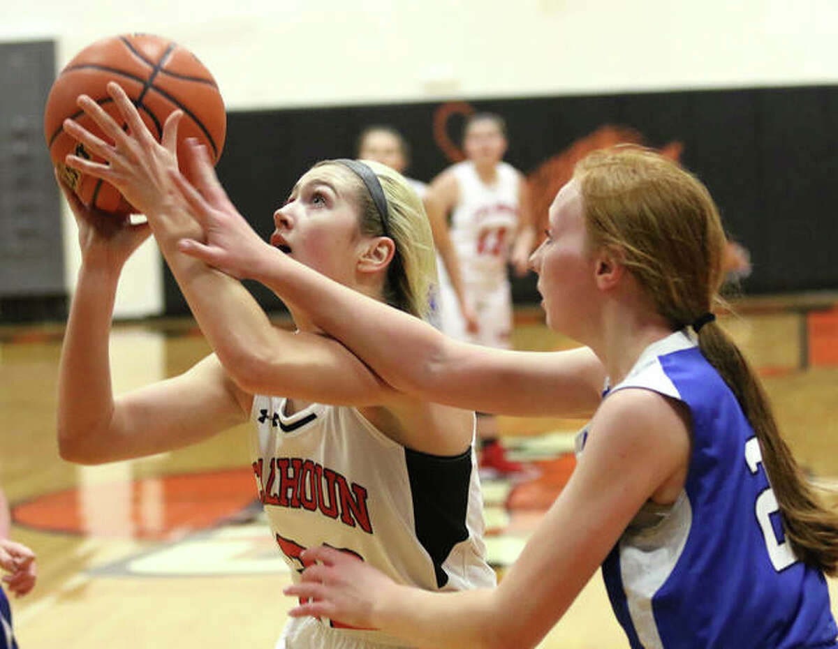 Calhoun’s Sophie Lorton (left) is fouled by Brussels’ Emma Clark in the first half of Monday night’s Greenfield Class 1A Regional quarterfinal.