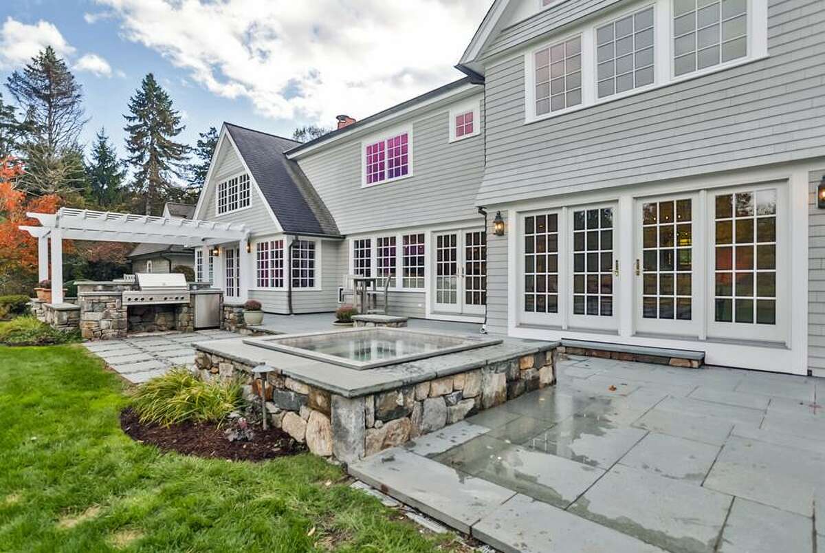 The bluestone patio features and outdoor kitchen and a luxurious stainless steel hot tub.