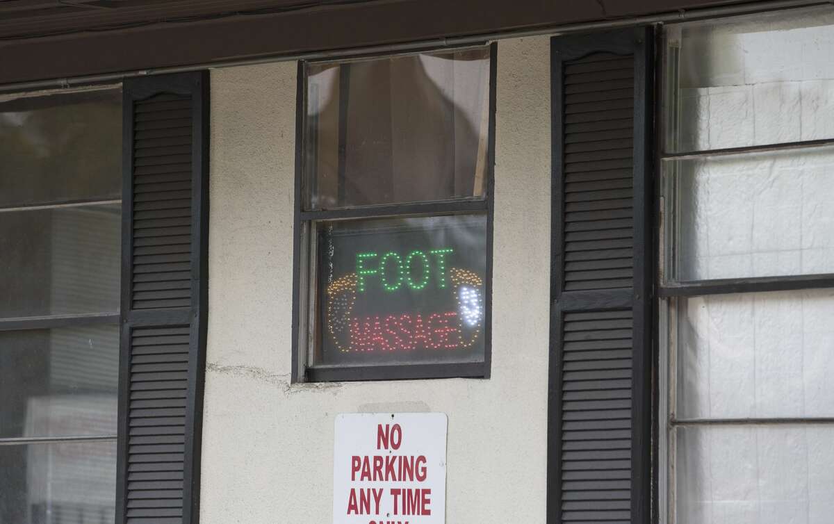 A foot massage sign shows this massage parlor on Richmond Avenue remains open after being sued by Harris County for being the front for prostitution Friday, Nov. 11, 2016, in Houston. (Yi-Chin Lee / Houston Chronicle )