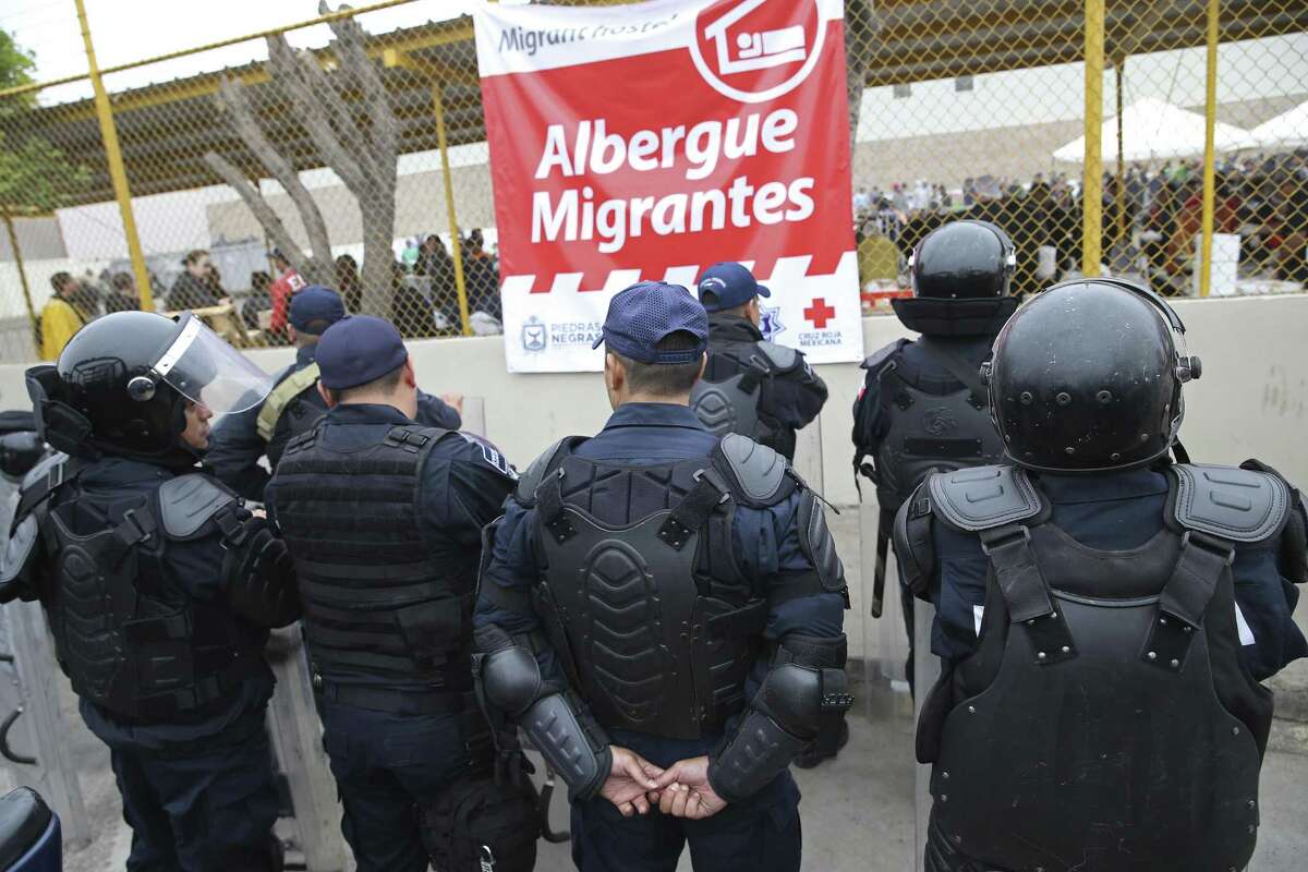 Mexican Federal Police wear riot gear as they guard the outside of a migrant shelter for Central American immigrants in Piedras Negras, Mexico, Tuesday, Feb. 5, 2019. The group numbering around 1,700 is at a state run shelter across the Rio Grande from Eagle Pass, Texas. The immigrants arrived on Monday and most are seeking asylum in the U.S. Immigrants with humanitarian visas issued by Mexico were allowed to leave the shelter.