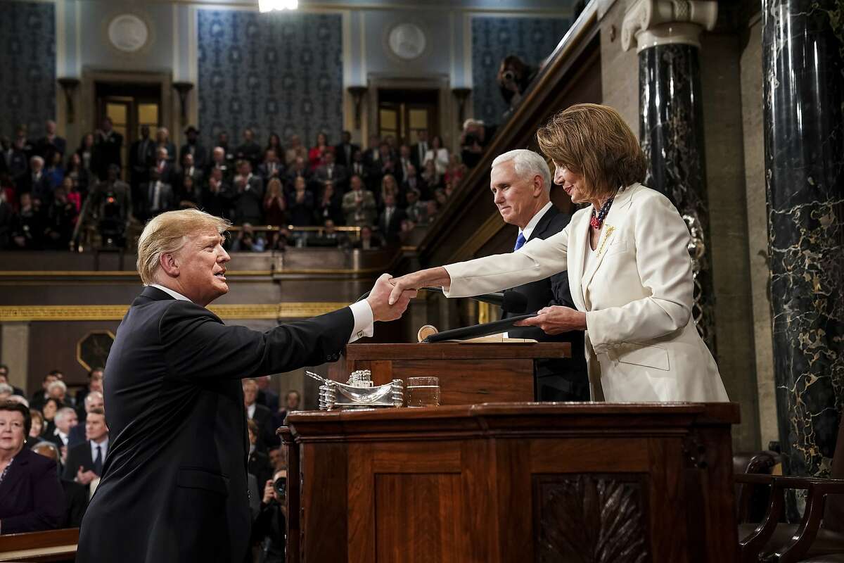 President Donald Trump shakes hands with House Speaker Nancy Pelosi as Vice President Mike Pence looks on, as he arrives in the House chamber before giving his State of the Union address to a joint session of Congress, Tuesday, Feb. 5, 2019 at the Capitol in Washington.