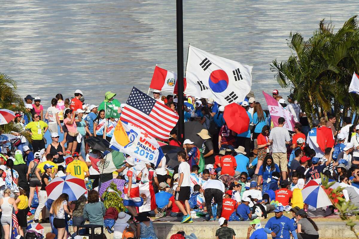 Young people holding flags from their countries take part in a Via Crucis procession with Pope Francis on the main highway running along Panama City's Pacific shoreline, on January 25, 2019. - The World Youth Day celebrations have drawn around 200,000 young people from around the world to Panama, where Pope Francis is expected to defend Central American migrants and human rights. (Photo by Luis Acosta / AFP)LUIS ACOSTA/AFP/Getty Images