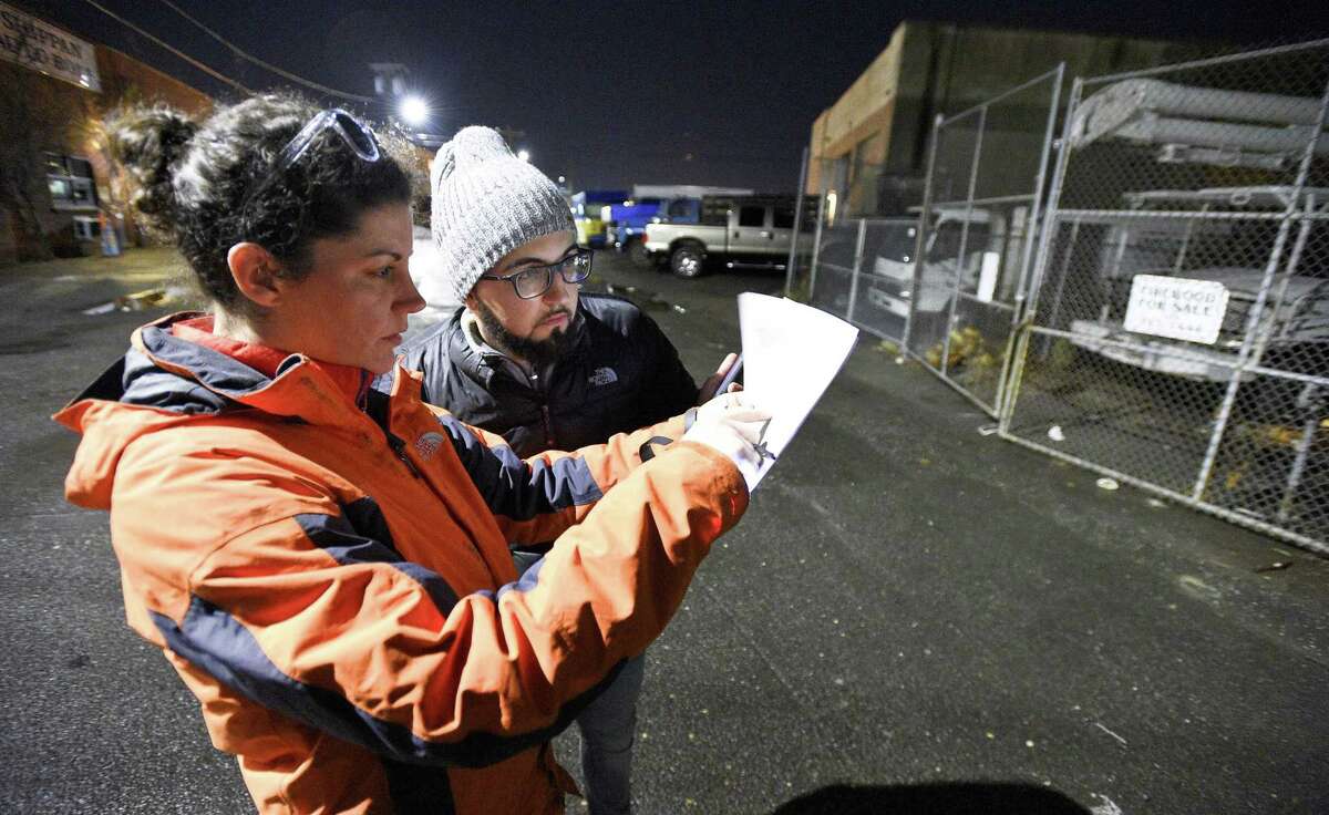 Micaela Marshall and Emmanuel Silva De Sousa check the Shippan business district during the annual point-in-time homeless count in Stamford Jan. 23, 2018.