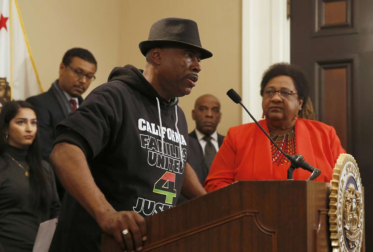 Cephus Johnson, the uncle of Oscar Grant who was killed by BART police n 2009 discusses his support for a measure by Assemblywoman Shirley Weber, D-San Diego, right, that would allow police to use deadly force only when there is no reasonable alternative, during a news conference, Wednesday, Feb. 6, 2019, in Sacramento, Calif. Weber's measure is one of two competing proposal over when police can use deadly force. (AP Photo/Rich Pedroncelli)