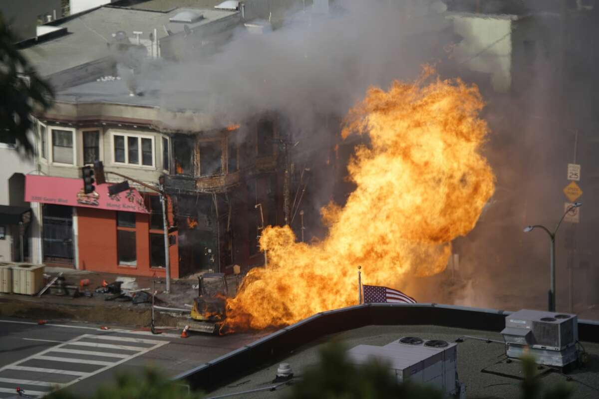 Firefighters battle a fire following an explosion at Geary boulevard and Parker Avenue on Wednesday, Feb. 6, 2019, in San Francisco, Calif.
