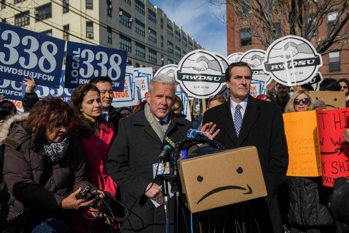 Council member Jimmy Van Bramer, center, Sen. Michael Gianaris (D-N.Y.), right, other council members and community members rally to oppose Amazon's subsidies next to the proposed Amazon headquarters site in Long Island City in New York, Nov. 14, 2018. The deal reached between Gov. Andrew M. Cuomo, Mayor Bill de Blasio and Amazon was constructed to blunt the veto power of local politicians. (Hiroko Masuike/The New York Times)
