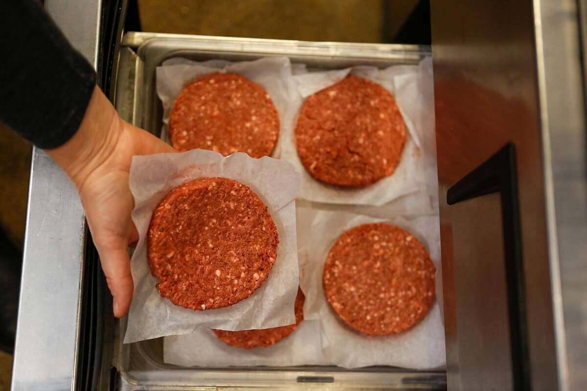 Gott's Culinary director, Jennifer Rebman, pulls out an Impossible burger pattie to put on the grill at Gott's on Wednesday, February 6, 2019 in San Francisco, Calif.