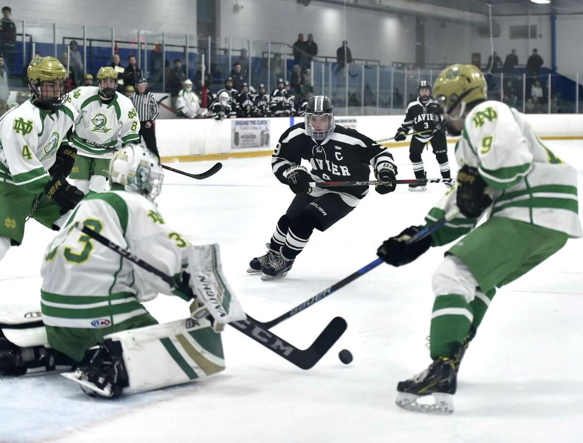 Notre Dame-West Haven goalie Connor Smith stops a shot on goal during the first period against Xavier at Bennett Rink in West Haven.