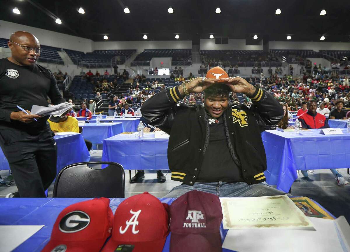 North Forest football coach Clifton Terrell with Javonne Shepherd as Shepherd picks Texas during National Signing Day.