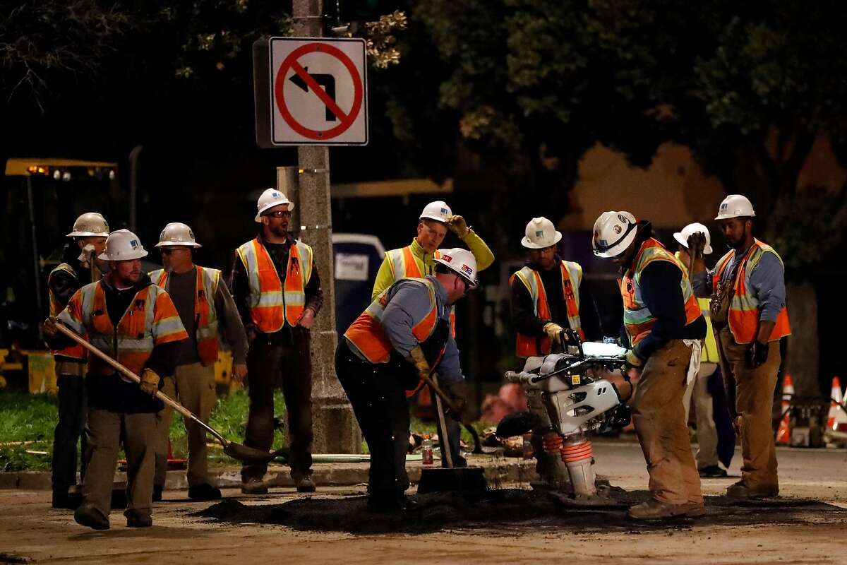PG&E personnel repair a section of street in aftermath of gas explosion at Geary Blvd. at Parker Avenue in San Francisco, Calif., on Wednesday, February 6, 2019.