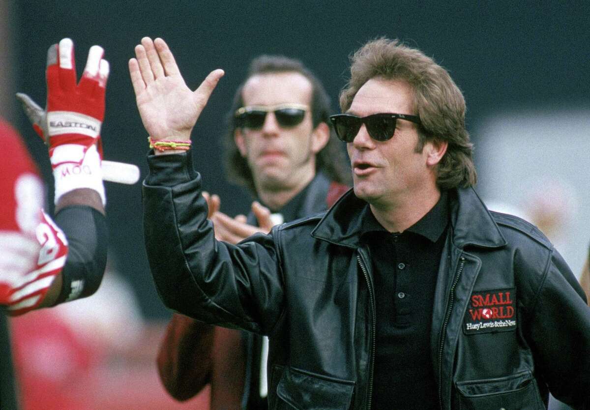 SAN FRANCISCO - JANUARY 20: Huey Lewis & the News perform the National Anthem before a game with the New York Giants taking on the San Francisco 49ers for the 1990 National Football Conference Division Playoffs at 3Com Park on January 12, 1991 in San Francisco, California. The 49ers won 28-10. (Photo by George Rose/Getty Images)