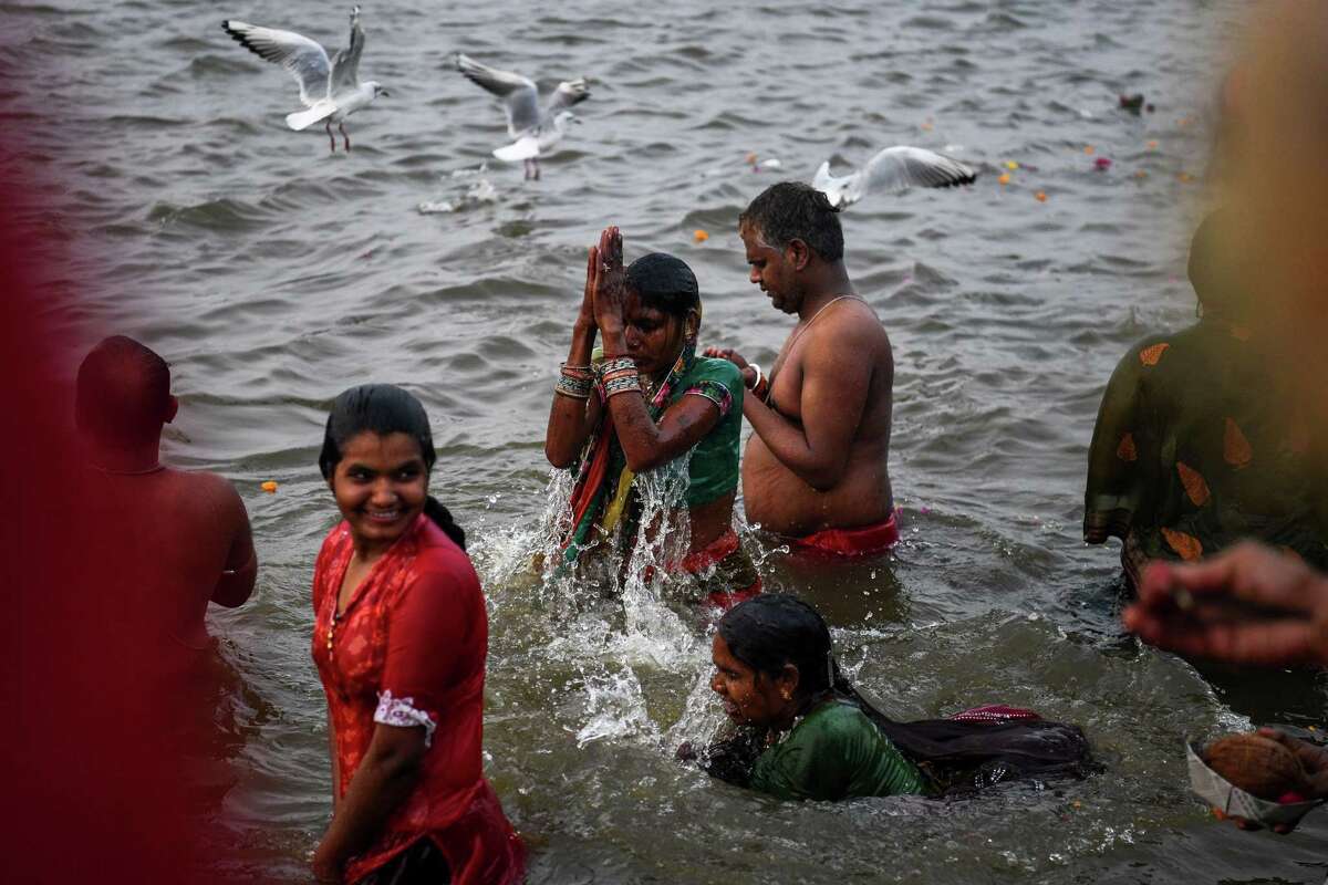 Indian devotees take a dip at the confluence of the Ganges, Yamuna and mythical Saraswati rivers, as people gather for the Kumbh Mela festival in Allahabad on January 14, 2019.The Ganges River is considered a holy place yet it also riddled with pollution, including 1.2 billion pounds of plastic waste dumped into its waters every year.
