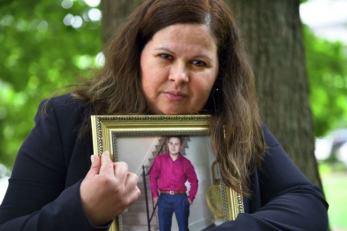 Bertha Morales holds a photograph of her son, Christian Villagran Morales, who was brutally murdered by members of the MS-13 gang in Montgomery County, Md., in 2016.