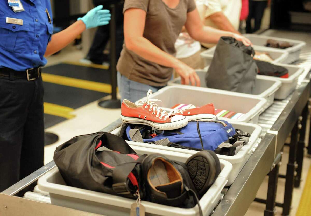 In this Aug. 3, 2011 photo, airline passengers retrieve their scanned belongings while going through the Transportation Security Administration security checkpoint at Hartsfield-Jackson Atlanta International Airport, in Atlanta. The TSA was created after the terrorist attacks of Sept. 11, 2001. (AP Photo/Erik S. Lesser)