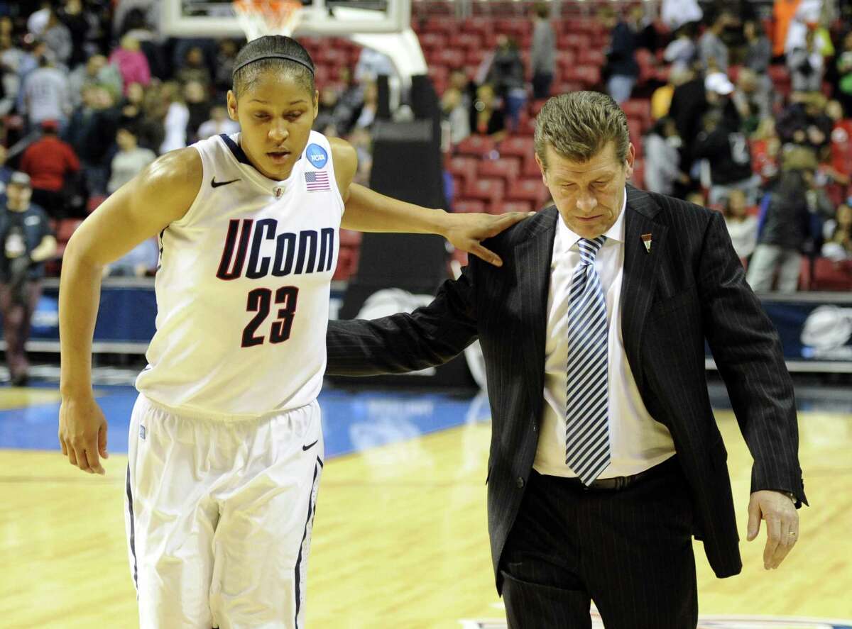 Maya Moore (23) walks off the court with head coach Geno Auriemma after defeating Georgetown 68-63 on March 27, 2011.