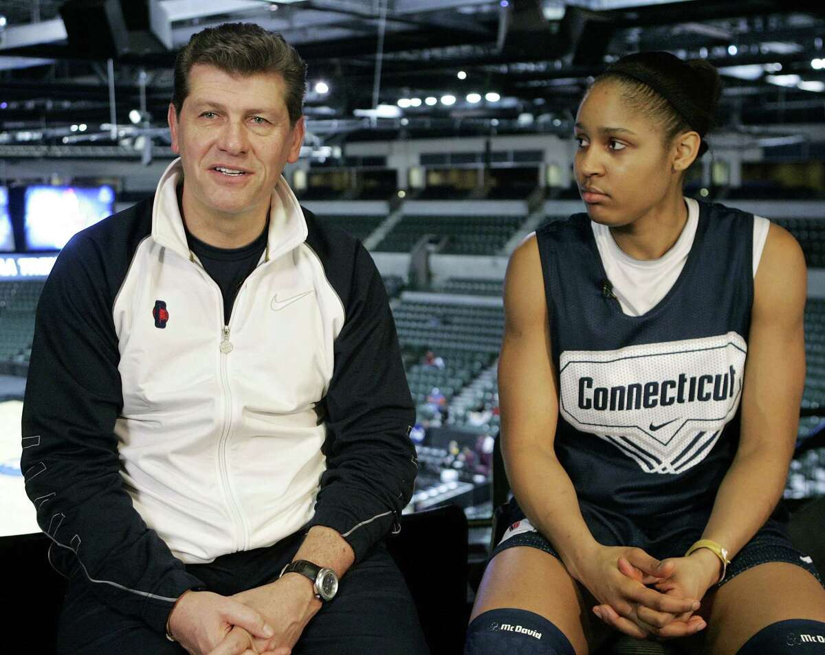 Maya Moore, right, looks on as UConn coach Gino Auriemma speaks during an interview at the women's NCAA college basketball Trenton Regional in Trenton, N.J. on Saturday, April 4, 2009.
