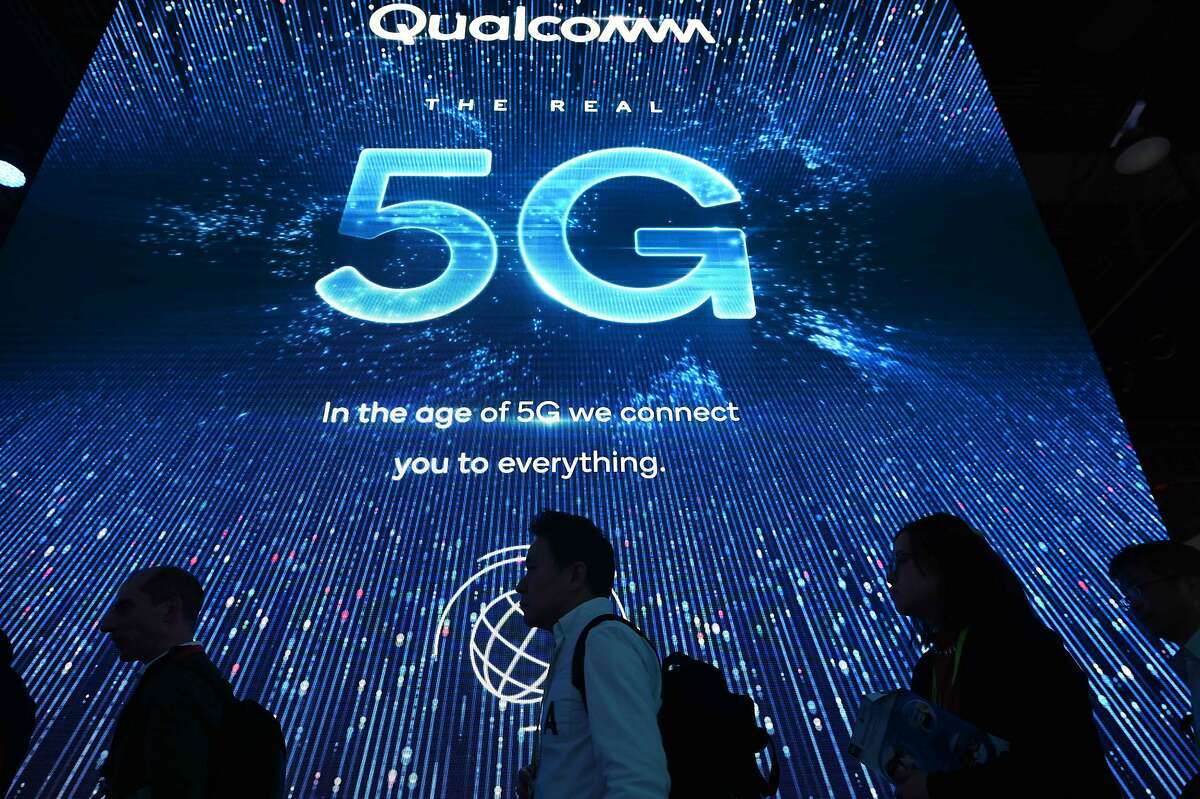 Attendees wait in line for a 5G exhibition at the Qualcomm booth during CES 2019 consumer electronics show, on January 10, 2019 at the Las Vegas Convention Center in Las Vegas, Nevada. (Photo by Robyn Beck / AFP)ROBYN BECK/AFP/Getty Images