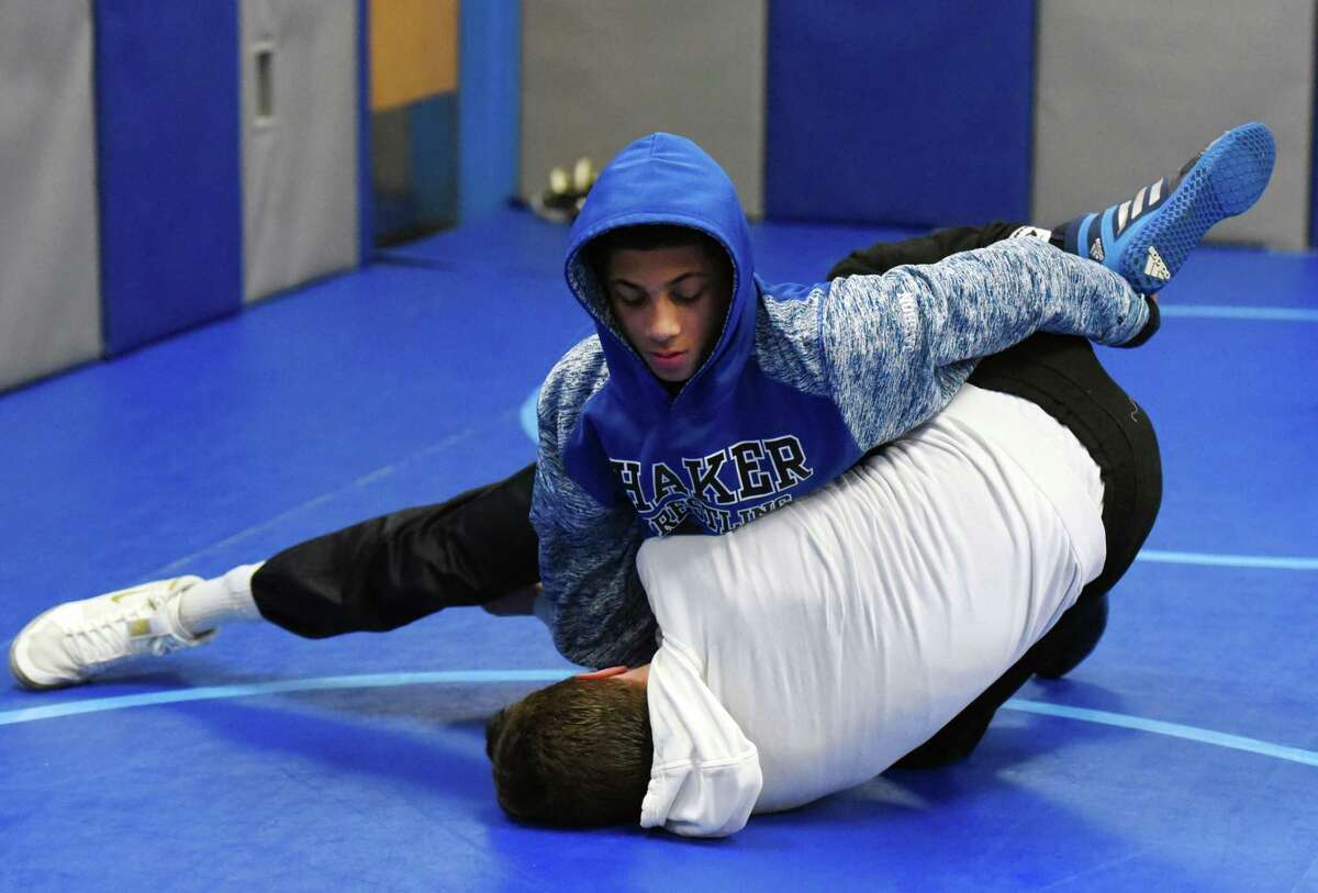 Jashon Holmes, top, wrestles Michael Santore for a drill during wrestling practice on Thursday, Feb. 7, 2019 at Shaker High School in Loudonville, NY. (Phoebe Sheehan/Times Union) ORG XMIT: 40046147A