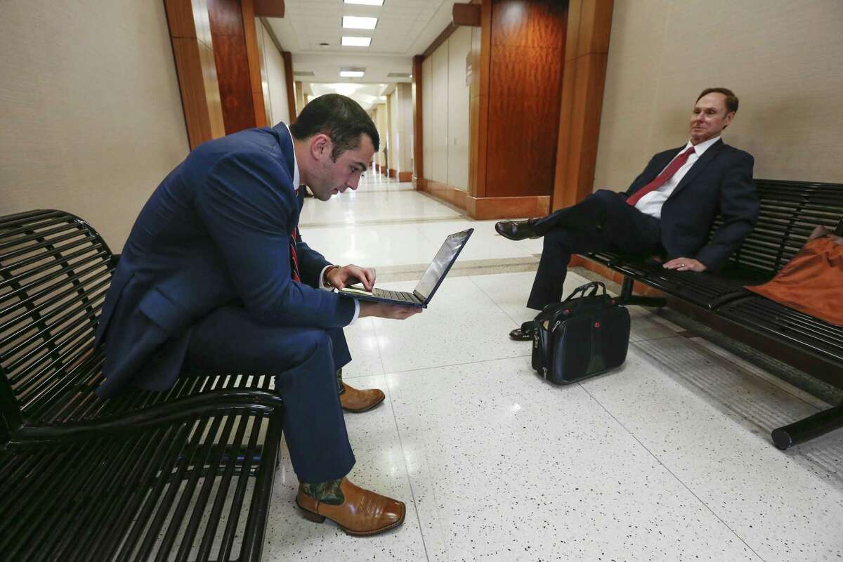 Assistant District Attorney Michael Hanover, left, talks to Tom Lewis outside the 174th Criminal District Court on Wednesday, Feb. 6, 2019, in Houston. Harris County District Attorney Kim Ogg is asking Commissioners Court for 100 new prosecutors to help clear a felony case backlog that was exacerbated by Hurricane Harvey.