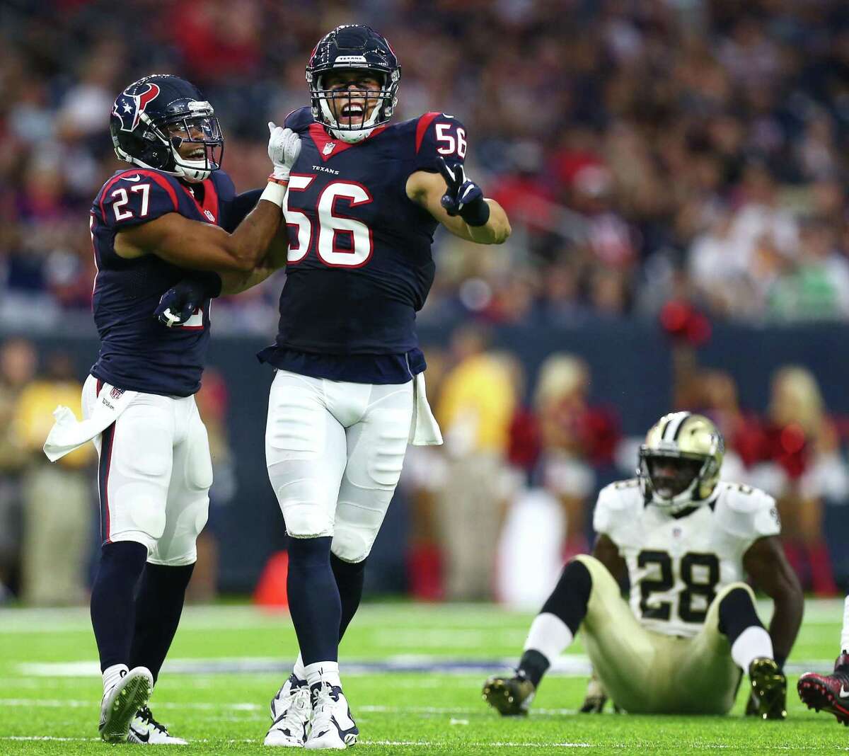 Brian Cushing, center, hopes to pass on what he learned in nine years as an NFL linebacker to the next generation of Texans.