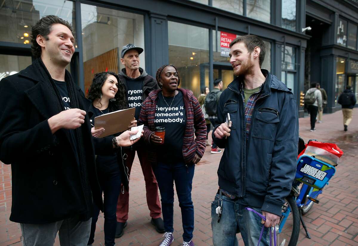 Kevin Adler (left) and his team from Miracle Messages reaches out to Brad Urmston-Parish (right), who is originally from New Jersey and was released from jail a day earlier, in San Francisco, Calif. on Tuesday, Jan. 29, 2019. At left is Brian Whitten, another community ambassador. Miracle Messages reconnects homeless people living on the street with long lost relatives and loved ones.
