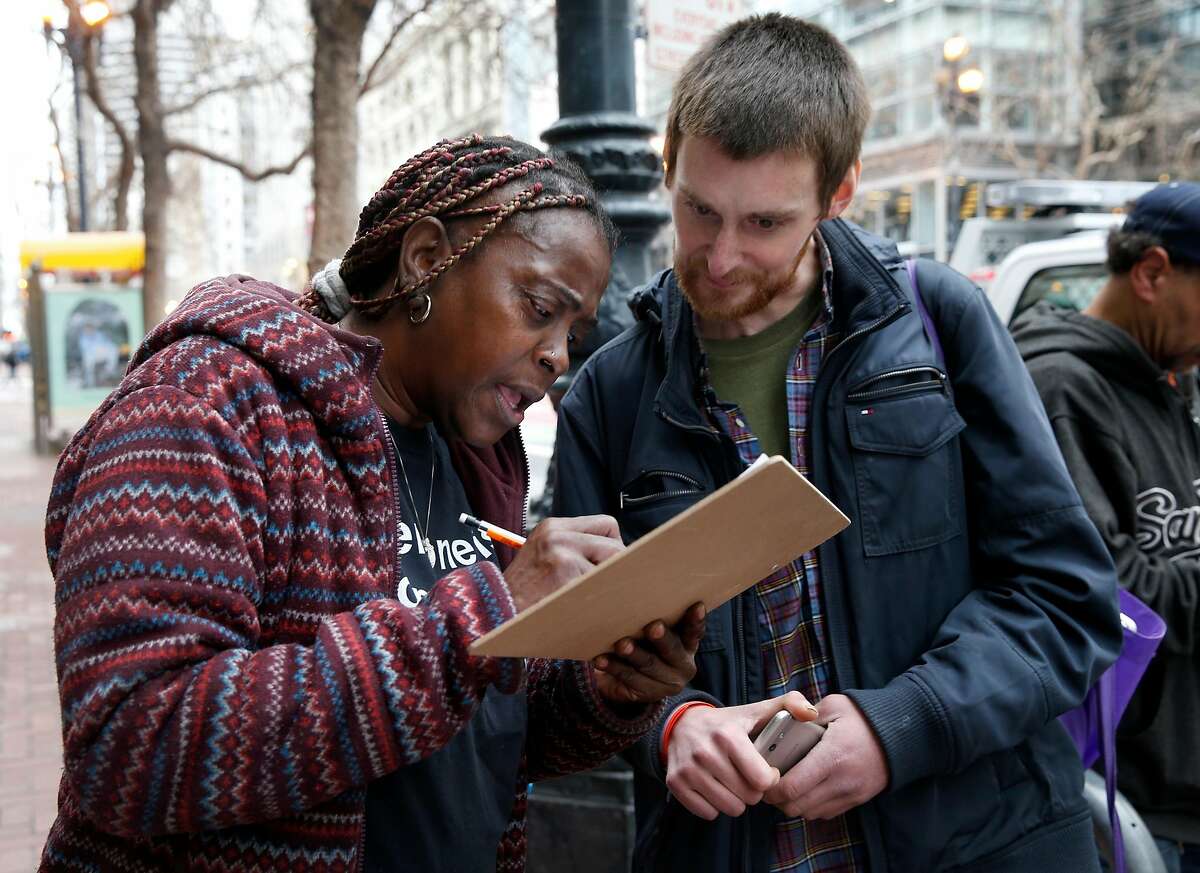 Beverly Stevenson, a community ambassador for Miracle Messages, fills out an intake form for Brad Urmston-Parish, who is originally from New Jersey and was released from jail a day earlier, in San Francisco, Calif. on Tuesday, Jan. 29, 2019. Miracle Messages reconnects homeless people living on the street with long lost relatives and loved ones.