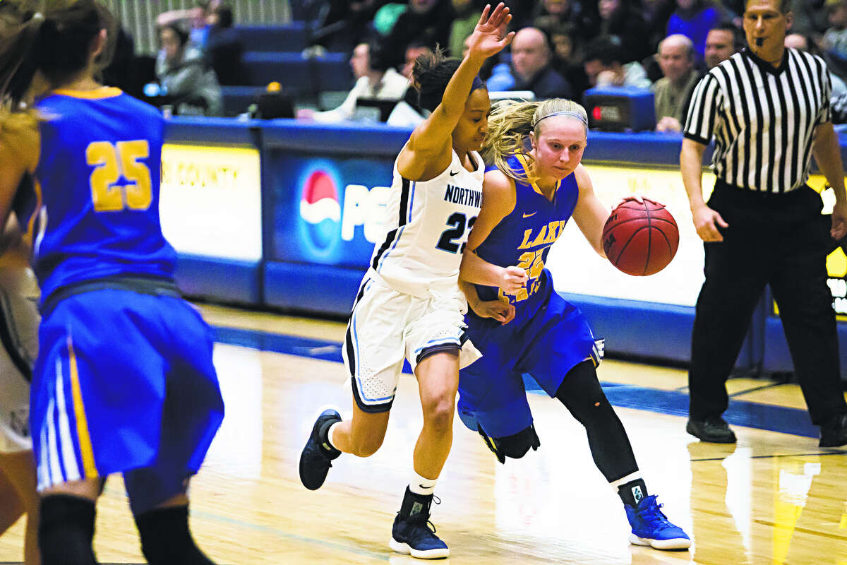 Lake Superior State's Sadie DeWildt brings the ball upcourt while being guarded by Norhtwood's Zakiya Wells during a Jan. 31, 2019 game.