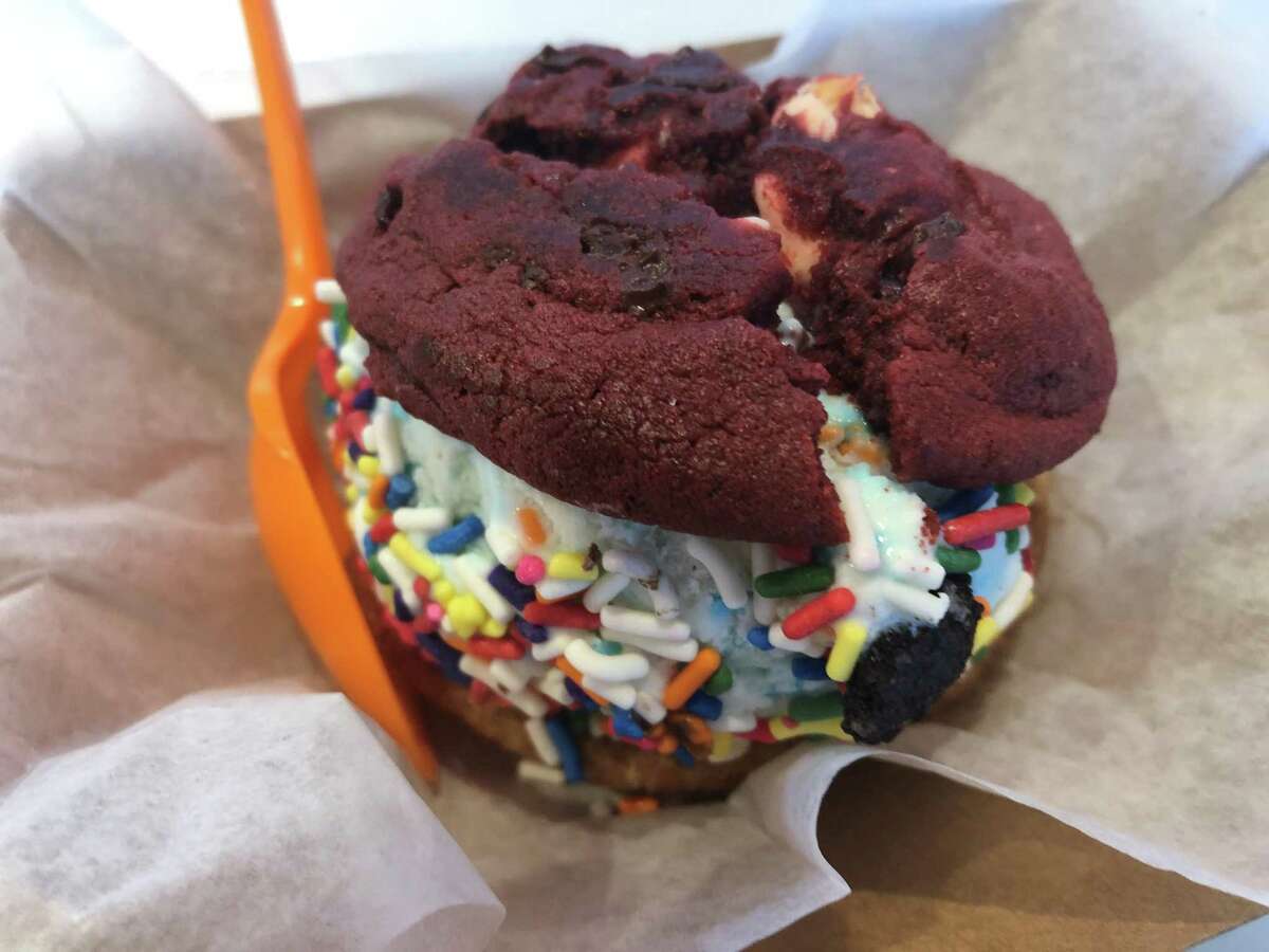 A tennis ball-sized scoop of birthday cake ice cream SMOOSHed in between a red velvet and snickerdoodle cookie, topped with rainbow sprinkles is just one of the many options Houston customers can choose from at SMOOSH, located in the Heights at 718 W. 18th St.