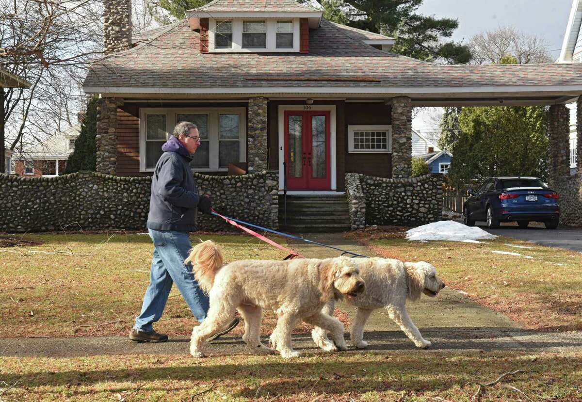 Nice days we come to an end on Tuesday when a stomr moves into the Capital Region. In this photo from Friday, Robert Coughlin of Albany walks his therapy dogs Babe Ruth and Lou Gehrig along Manning Boulevard. (Lori Van Buren/Times Union)