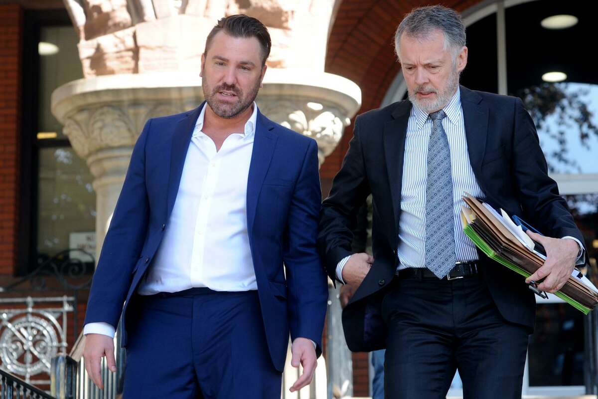Fairfield Police Detective Stephen Rilling, left, leaves Bridgeport Superior Court following his arraignment in Bridgeport, Conn. June 2, 2017. Rilling, son of Norwalk Mayor Harry Rilling, is charged with third-degree computer crime, second-degree larceny by defrauding a public community, possession of narcotics, second-degree forgery, tampering with evidence and false entry by an officer or agent of a public community. Rilling is seen here with his attorney, John Gulash.