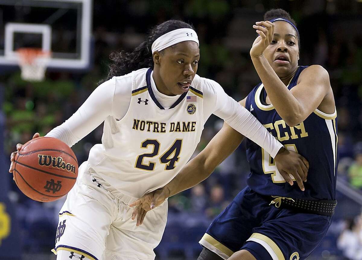 Notre Dame's Arike Ogunbowale (24) drives by Georgia Tech's Kierra Fletcher during the first half of an NCAA college basketball game Sunday, Feb. 3, 2019, in South Bend, Ind. (AP Photo/Robert Franklin)
