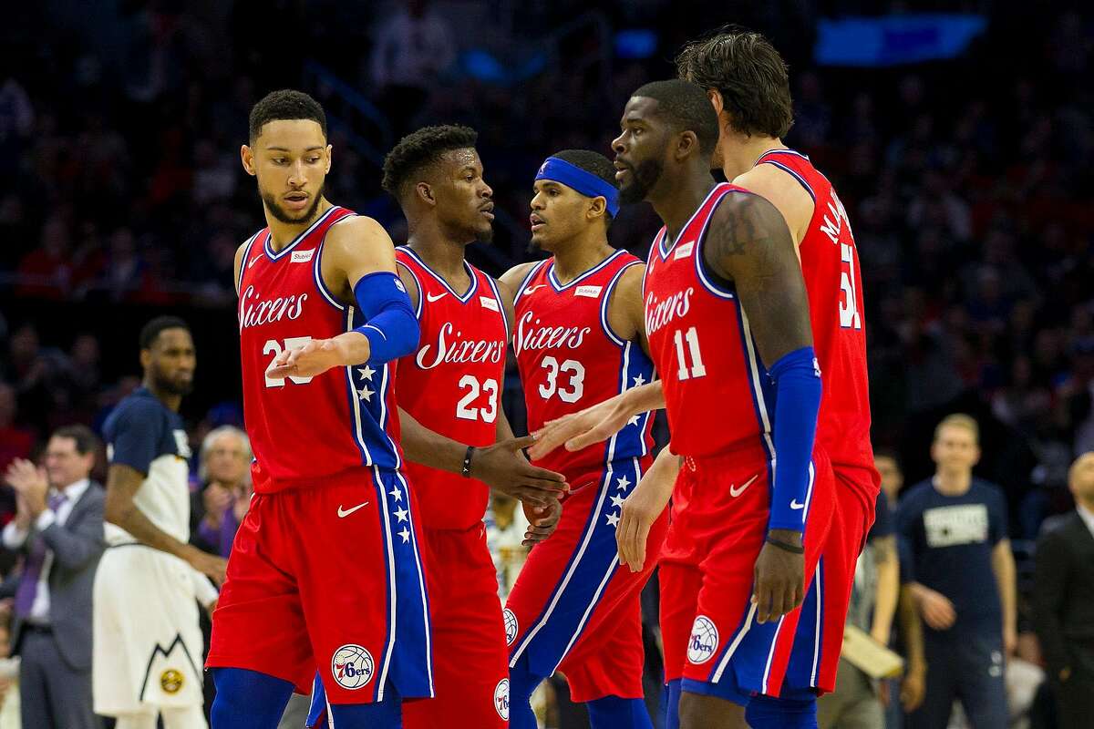 The Philadelphia 76ers', from left, Ben Simmons, Jimmy Butler, Tobias Harris, James Ennis, and Boban Marjanovic congratulate one another after a timeout in the second quarter against the Denver Nuggets at the Wells Fargo Center in Philadelphia on Friday, Feb. 8, 2019. The Sixers won, 117-110. **FOR USE WITH THIS STORY ONLY**(Mitchell Leff/Getty Images/TNS)