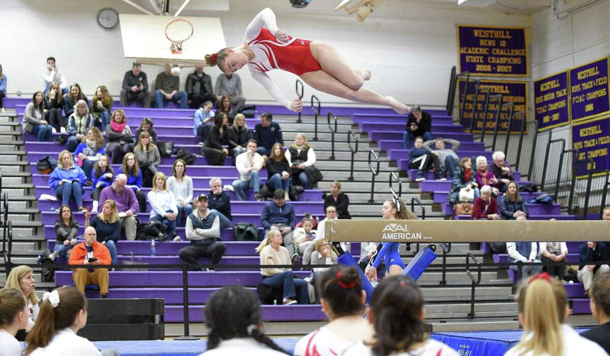 Greenwich's Kelsey Fedorko makes her dismount from the beam in the Ro Carlucci FCIAC Championship Meet in gymnastics at Westhill High School in Stamford, Conn. on Saturday, Feb. 9, 2019.
