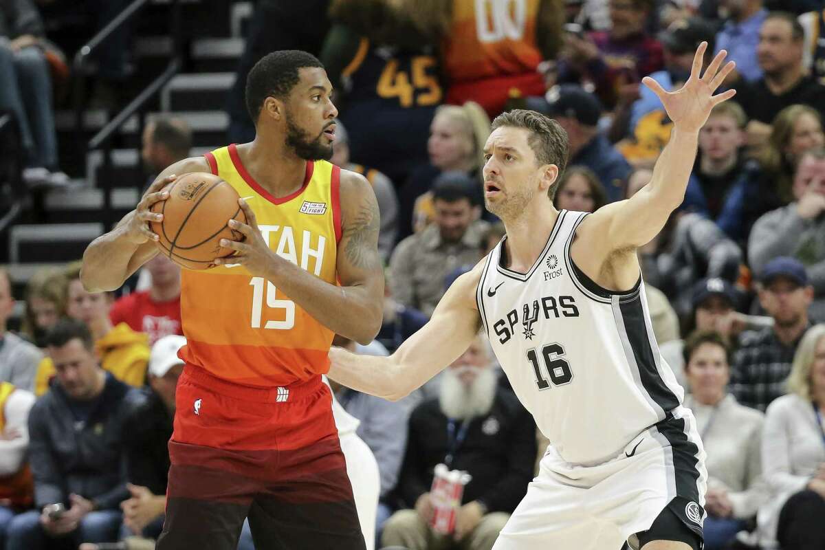 Spurs big man Pau Gasol, right, defending the Jazz’s Derrick Favors, scored five points in seven minutes of action. Gasol has been relegated to spot play since a foot injury early in the season.