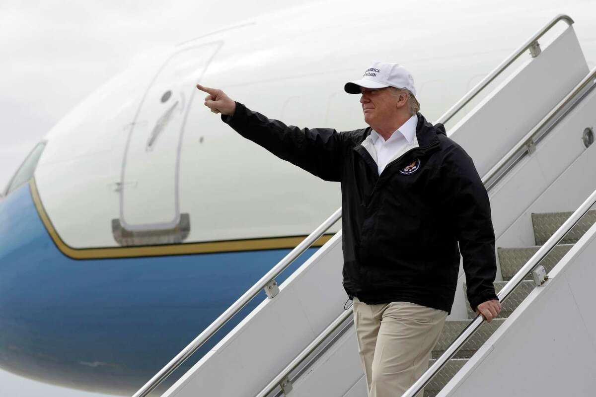 In this Jan. 10, 2019, photo, President Donald Trump gestures after arriving at McAllen International Airport for a visit to the southern border in McAllen, Texas. Trump scrapped a trip to Switzerland later this month, citing the partial government shutdown. But he did jet this week to the southwestern border to continue pressing for a border wall, the issue that forced the shutdown in the first place, and he plans to give a speech to farmers Monday in New Orleans. (AP Photo/ Evan Vucci)