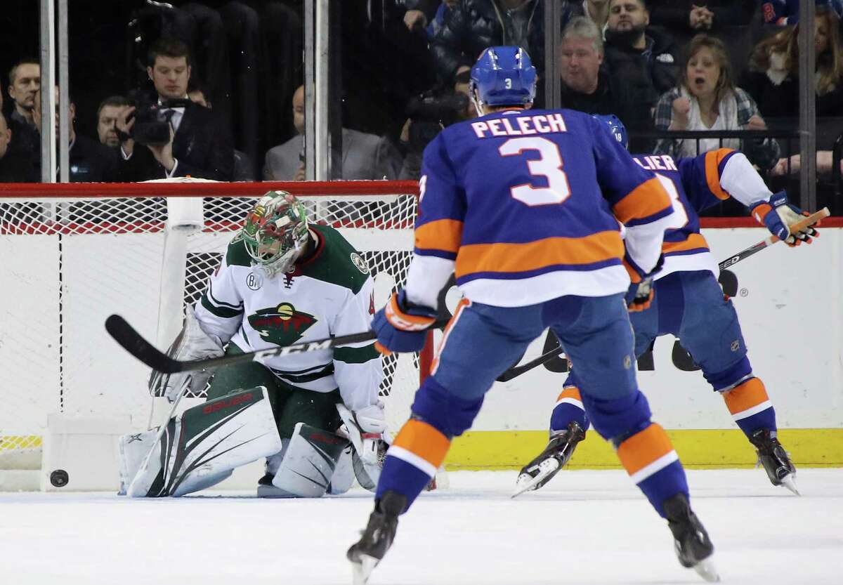 NEW YORK, NEW YORK - FEBRUARY 10: Anthony Beauvillier #18 of the New York Islanders (r) celebrates a first period goal against Devan Dubnyk #40 of the Minnesota Wild at the Barclays Center on February 10, 2019 in the Brooklyn borough of New York City. (Photo by Bruce Bennett/Getty Images)