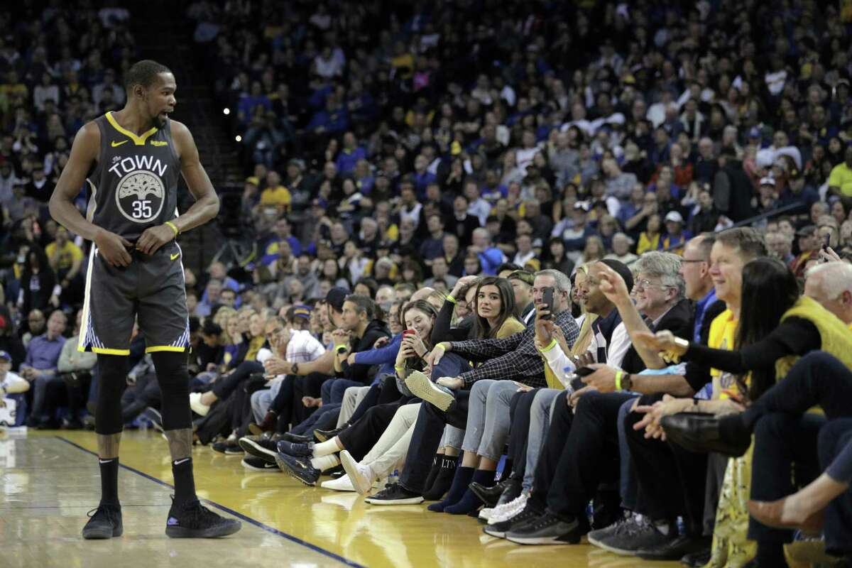 Kevin Durant (35) makes his case to the fans in the front row after referee Jason Goldenberg (35) gave him a technical foul in the second half as the Golden State Warriors played the Miami Heat at Oracle Arena in Oakland, Calif., on Sunday, February 10, 2019.