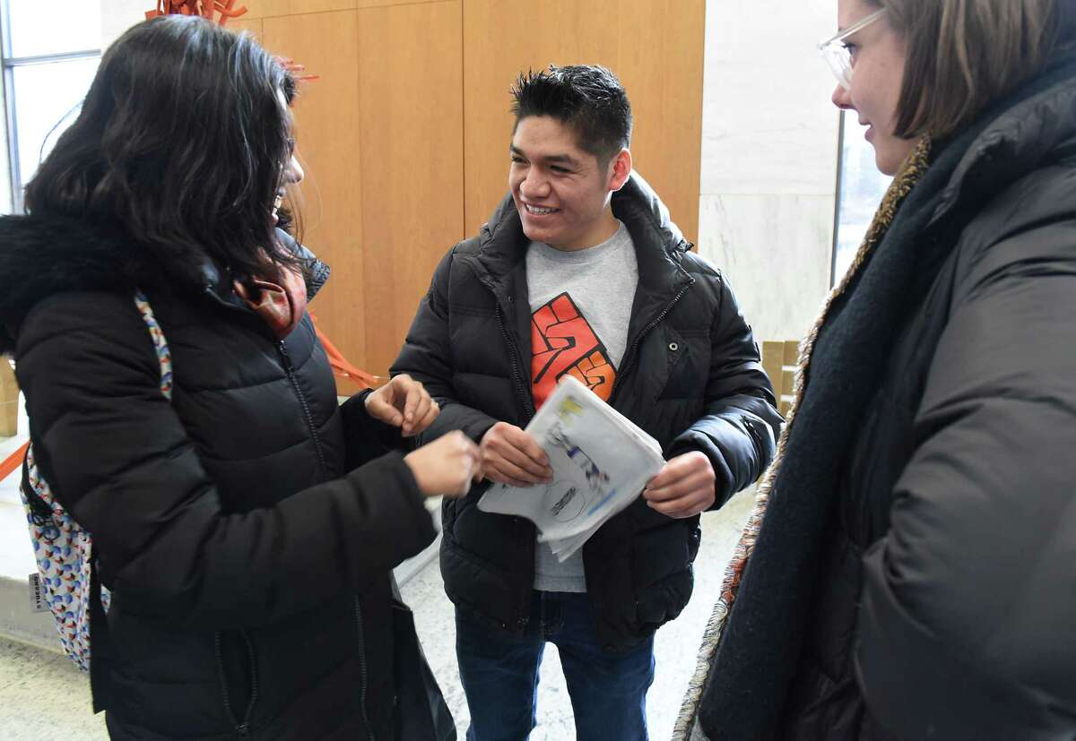 Farmworker Crispin Hernandez, center, talks women from the New York Cilvil Liberties Union after the Albany Supreme Court heard his oral arguments in a case against the state and the Farm Bureau in the Robert Abrams Building on Monday Feb. 11, 2019 in Albany, N.Y. Hernandez is suing the state and the Farm Bureau for the exclusion of farmworkers from the right to organize and collectively bargain without fear of retaliation like other workers. (Lori Van Buren/Times Union)