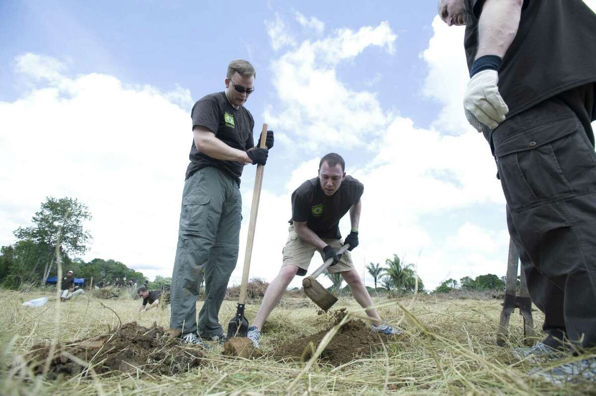 Crius Energy and Viridian CEO Michael Fallquist (left) works in 2011 in Brazil alongside independent Viridian associates on the first phase of Viridian's "Seven Continents in Seven Years" initiative to undertake environmental sustainability projects globally. (Photo: Business Wire)
